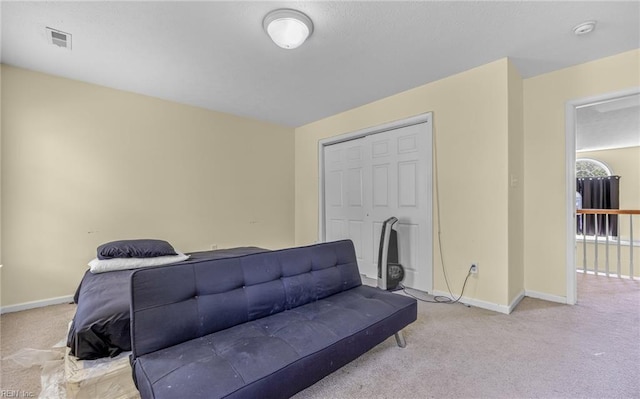 carpeted living area with visible vents and baseboards