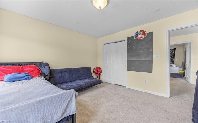 bedroom featuring a closet, carpet, and baseboards