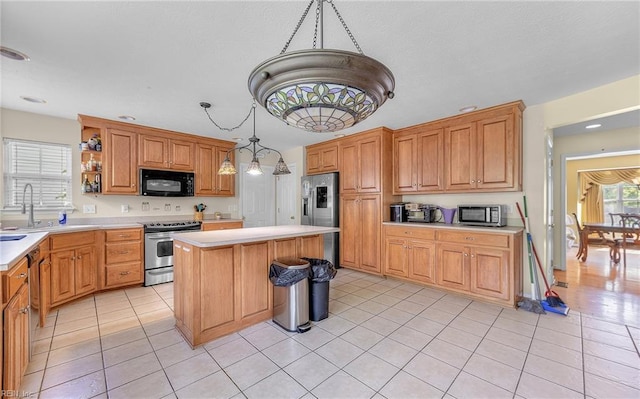 kitchen with light tile patterned flooring, stainless steel appliances, light countertops, and a sink
