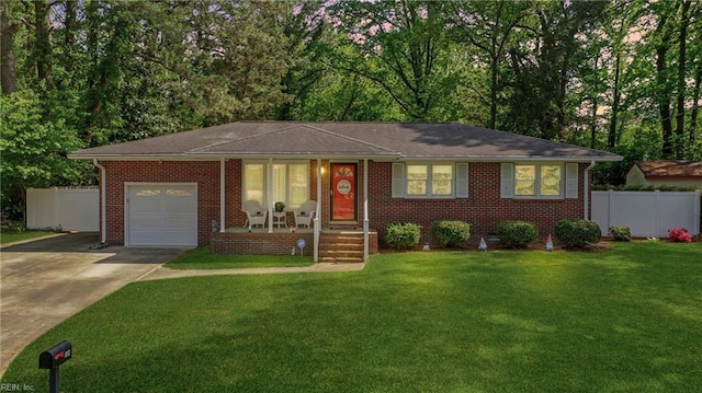 ranch-style house featuring concrete driveway, an attached garage, fence, a front yard, and brick siding