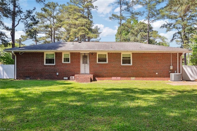 back of property with crawl space, fence, a yard, entry steps, and brick siding
