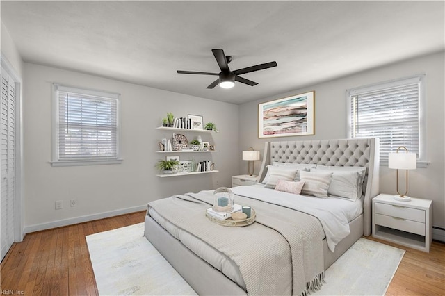 bedroom with wood finished floors, baseboards, and a ceiling fan