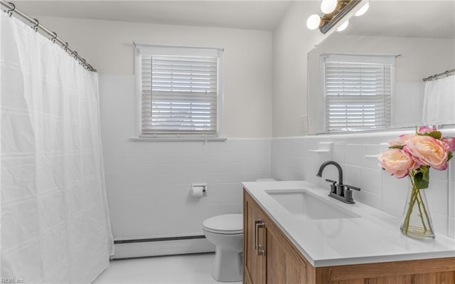 bathroom featuring baseboard heating, vanity, a wealth of natural light, and toilet
