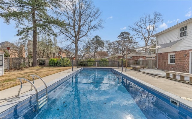 view of swimming pool featuring a fenced backyard, a patio area, and a fenced in pool