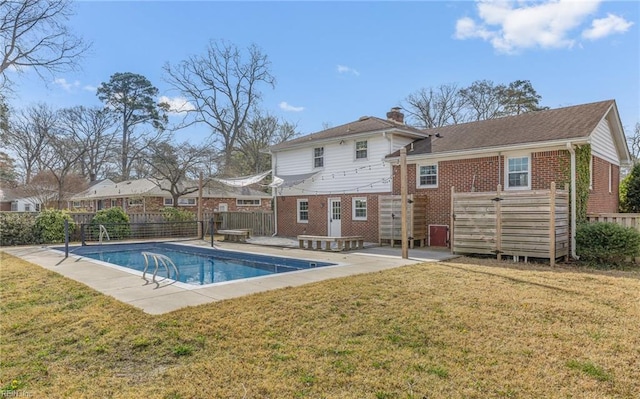view of pool featuring a patio area, fence, a yard, and a fenced in pool