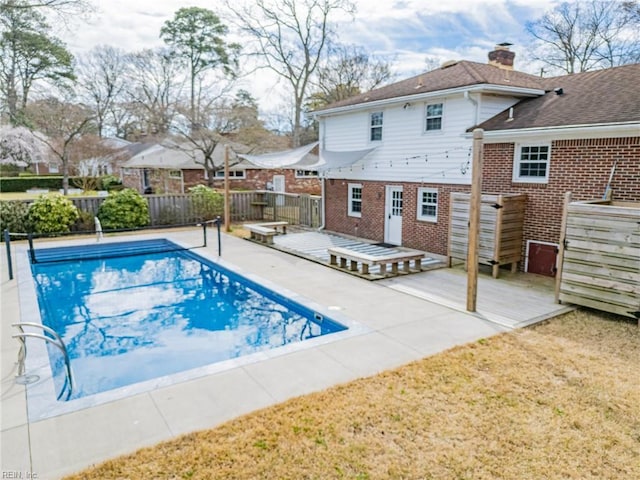 view of swimming pool with fence, a fenced in pool, and a deck