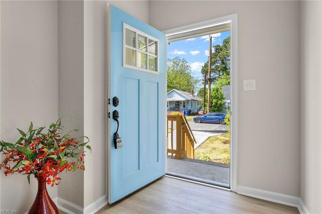 entryway featuring baseboards and light wood-style flooring