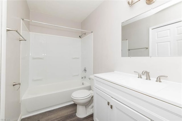 full bathroom featuring wood finished floors, toilet, bathtub / shower combination, and vanity