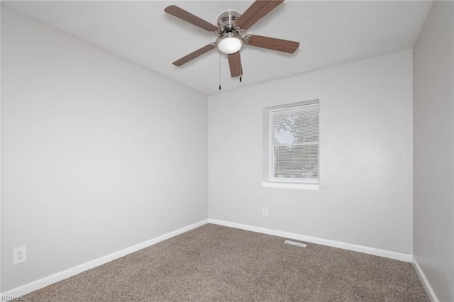 spare room with carpet and baseboards