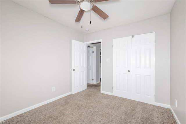 unfurnished bedroom with a ceiling fan, carpet floors, and baseboards