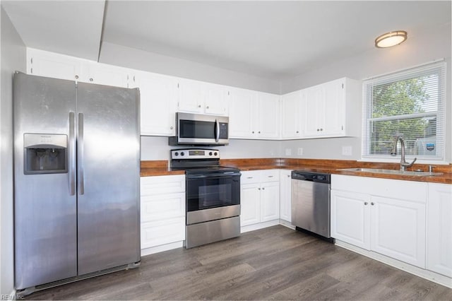 kitchen with white cabinetry, stainless steel appliances, and a sink