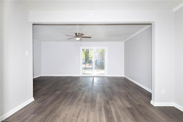 spare room featuring ceiling fan, dark wood-style floors, and baseboards