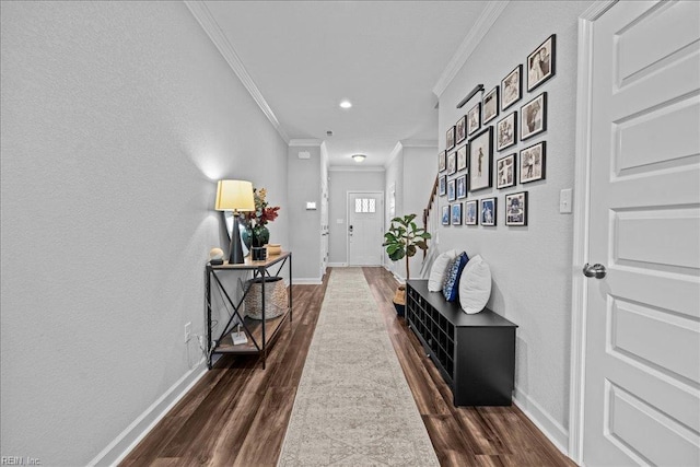 hallway featuring baseboards, ornamental molding, and dark wood-type flooring