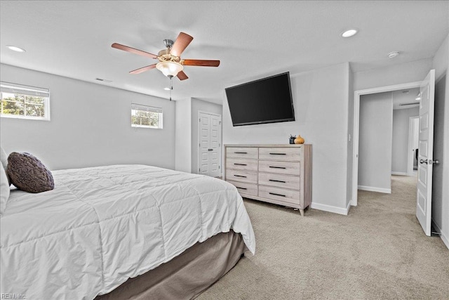 bedroom featuring ceiling fan, visible vents, light colored carpet, baseboards, and recessed lighting