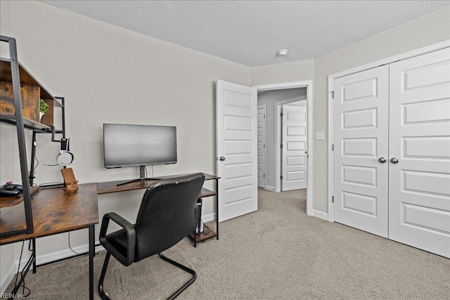 office space with baseboards, carpet, and a textured ceiling