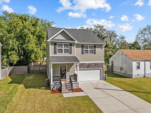 traditional home featuring fence, an attached garage, a porch, a front yard, and concrete driveway