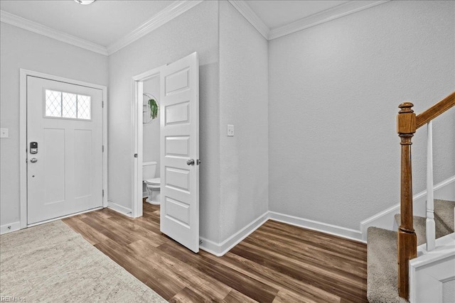 entryway featuring crown molding, baseboards, stairs, and wood finished floors