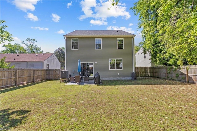 back of house with a fenced backyard, a yard, central AC, and a patio area