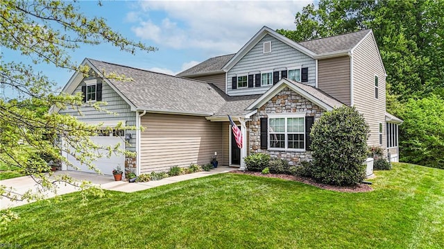view of front of house with concrete driveway, roof with shingles, stone siding, and a front yard