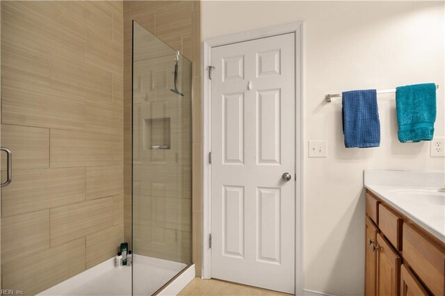full bathroom with baseboards, vanity, and a stall shower