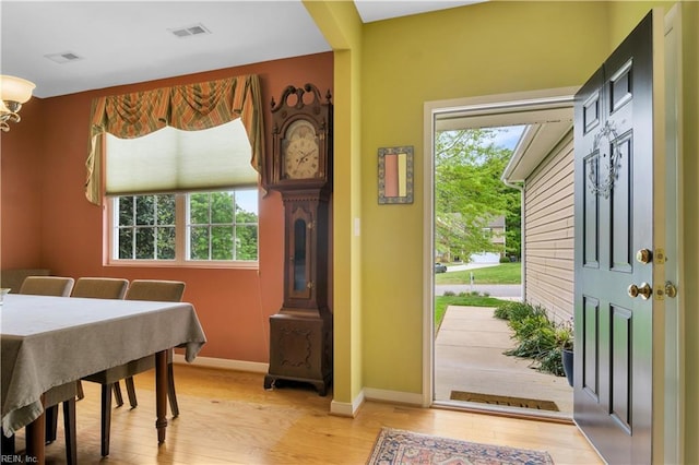 interior space featuring light wood-type flooring, visible vents, and baseboards