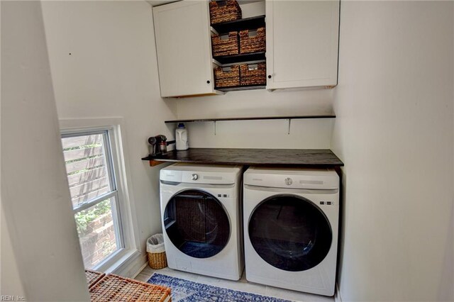 laundry room featuring washer and clothes dryer and cabinet space