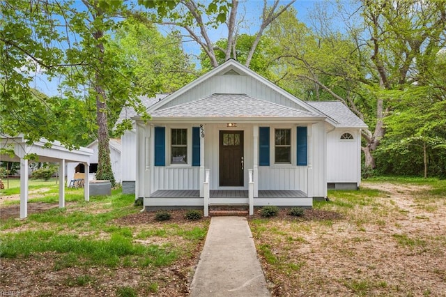 bungalow-style house with board and batten siding, a porch, and a shingled roof