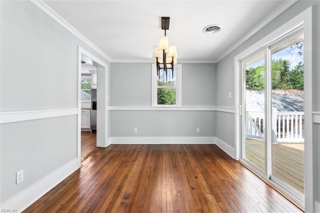 unfurnished dining area featuring wood-type flooring, a wealth of natural light, and a chandelier