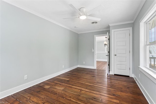 empty room featuring visible vents, ceiling fan, baseboards, dark wood-style flooring, and ornamental molding