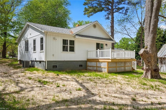 back of house with a wooden deck, crawl space, central AC, a chimney, and roof with shingles