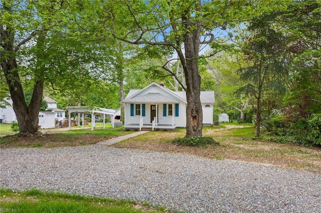 bungalow-style house featuring gravel driveway and covered porch