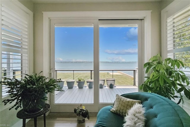 sunroom / solarium with a water view