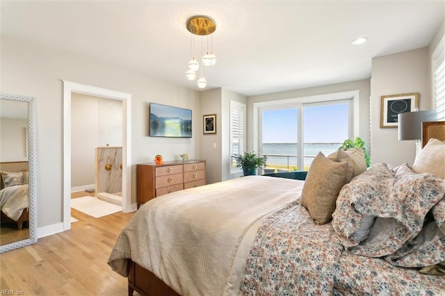 bedroom featuring baseboards, recessed lighting, light wood-style flooring, and multiple windows