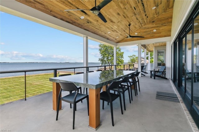 sunroom featuring a water view