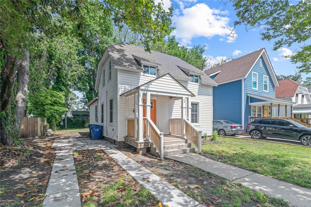 bungalow with a front yard, a shingled roof, and fence