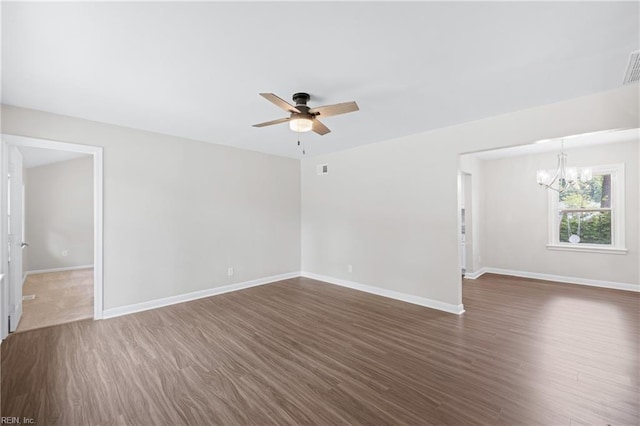 spare room with visible vents, baseboards, dark wood-style flooring, and ceiling fan with notable chandelier