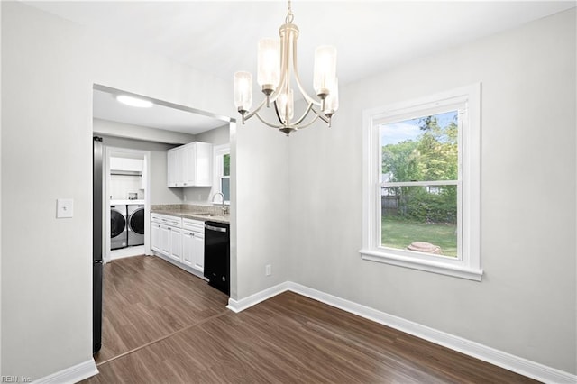 kitchen featuring white cabinets, baseboards, a notable chandelier, dishwasher, and washer and dryer