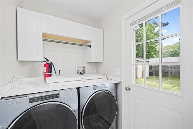 clothes washing area featuring independent washer and dryer, plenty of natural light, and laundry area