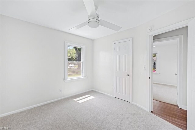 unfurnished bedroom with baseboards, carpet floors, a closet, and ceiling fan