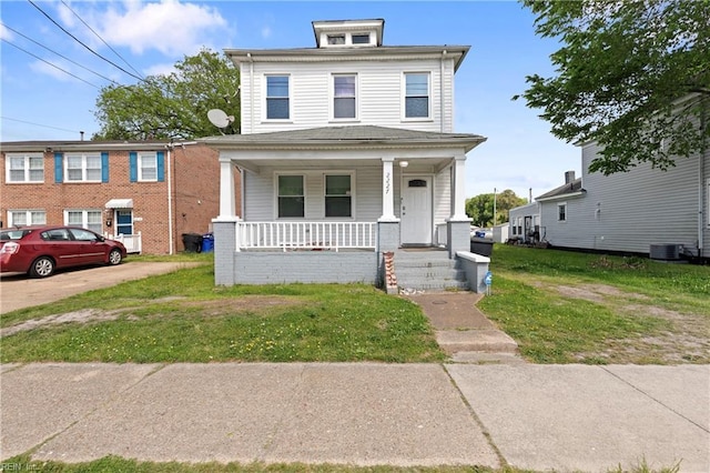 traditional style home featuring covered porch and a front lawn
