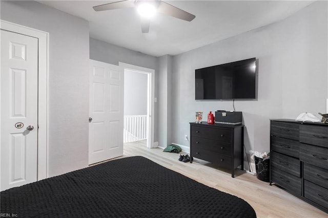 bedroom with ceiling fan and light wood-style floors