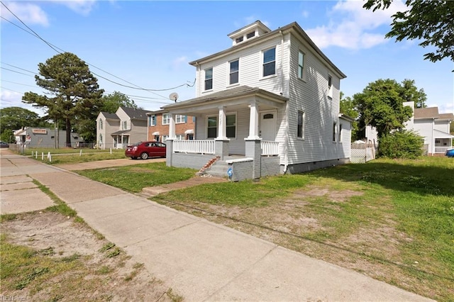 traditional style home featuring a porch, a front yard, and crawl space
