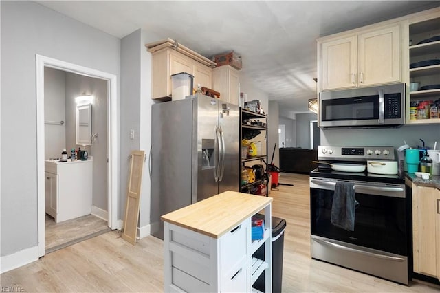 kitchen featuring wood counters, stainless steel appliances, open shelves, light wood-type flooring, and baseboards