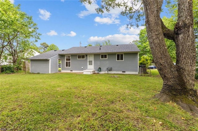 rear view of property with a lawn and fence