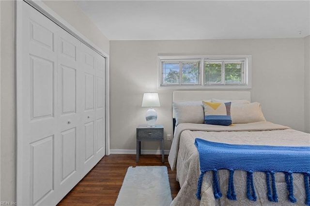 bedroom featuring a closet, baseboards, and dark wood-type flooring