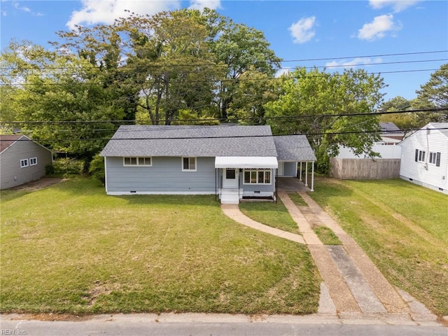 view of front facade with a front lawn, crawl space, an attached carport, concrete driveway, and fence