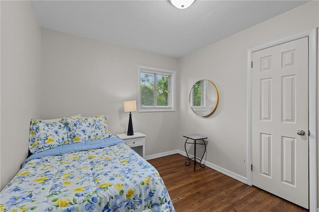 bedroom featuring dark wood-style floors and baseboards
