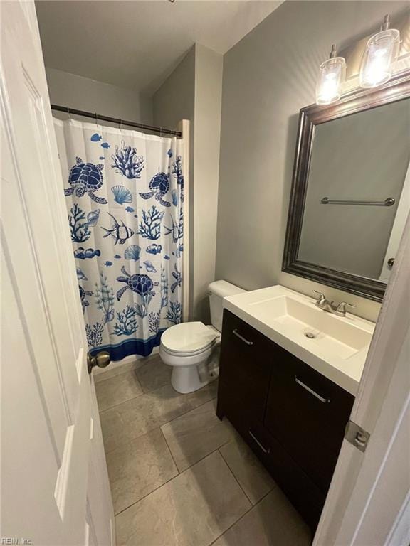 full bathroom with vanity, toilet, and curtained shower