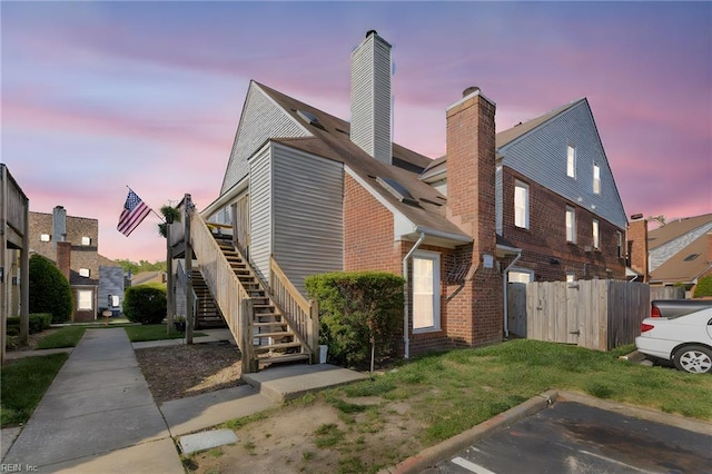 5081 Gatehouse Way, Virginia Beach, VA 23455 - view of front of property with a chimney, brick siding, fence, uncovered parking, and stairs