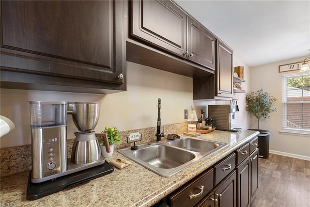 5081 Gatehouse Way, Virginia Beach, VA 23455 - kitchen featuring a sink, light countertops, dark brown cabinets, baseboards, and light wood-type flooring